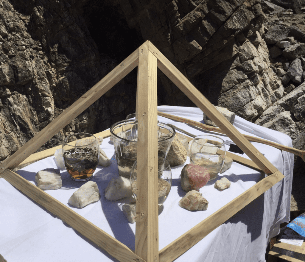 A table with rocks and a glass on it